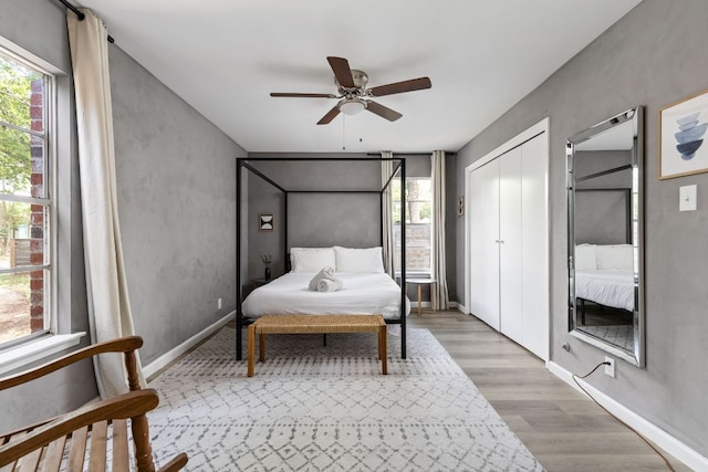 4911 Brighton Rd, Austin, TX 78745 - bedroom featuring light wood-style floors, multiple windows, and ceiling fan