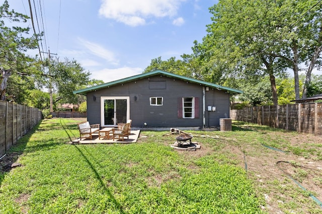 4911 Brighton Rd, Austin, TX 78745 - rear view of property with a fenced backyard and an outdoor living space with a fire pit