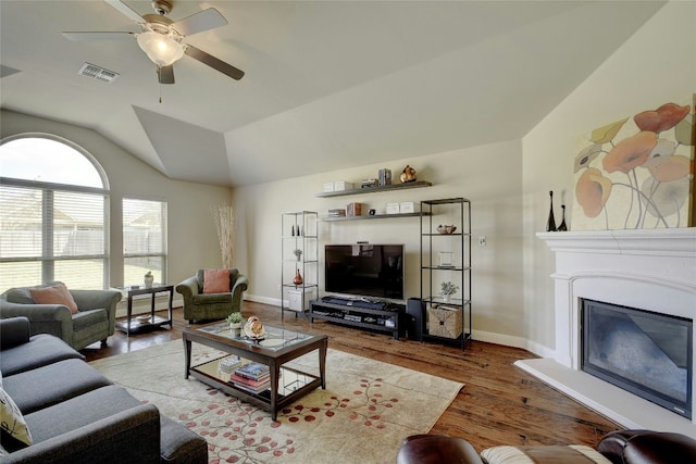 578 Ledge Stone Dr, Austin, TX 78737 - living room featuring ceiling fan, wood finished floors, vaulted ceiling, and a glass covered fireplace