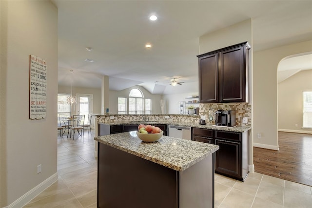 578 Ledge Stone Dr, Austin, TX 78737 - kitchen with a ceiling fan, arched walkways, a peninsula, lofted ceiling, and stainless steel dishwasher