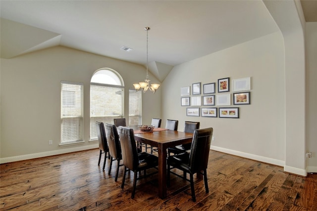 578 Ledge Stone Dr, Austin, TX 78737 - dining area with lofted ceiling, dark wood-type flooring, a chandelier, and arched walkways