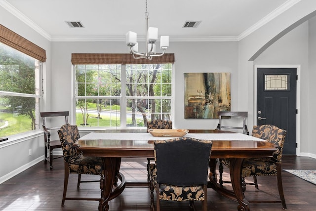 4112 Seldalia Trl, Austin, TX 78732 - dining room featuring a chandelier, crown molding, dark wood finished floors, and arched walkways