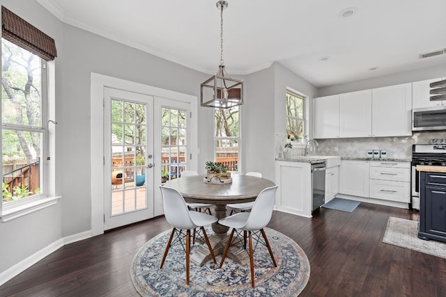 4112 Seldalia Trl, Austin, TX 78732 - dining area featuring dark wood-style flooring, plenty of natural light, a chandelier, ornamental molding, and french doors