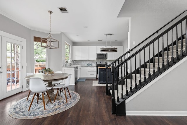 4112 Seldalia Trl, Austin, TX 78732 - dining area featuring stairs, dark wood-style floors, and a chandelier