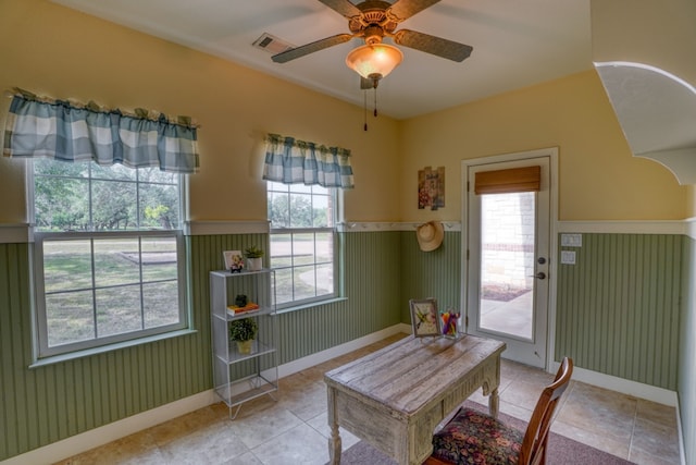 1050 Twisted Oak Dr, Horseshoe Bay, TX 78657 - tiled dining space featuring a wainscoted wall, plenty of natural light, and a ceiling fan