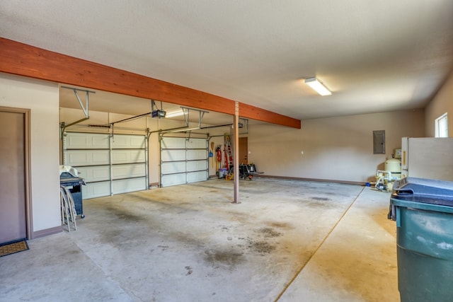 1050 Twisted Oak Dr, Horseshoe Bay, TX 78657 - garage featuring freestanding refrigerator, electric panel, and a garage door opener