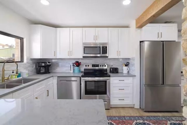 17708 Cherry Ln, Lago Vista, TX 78645 - kitchen featuring stainless steel appliances, white cabinets, light countertops, tasteful backsplash, and recessed lighting