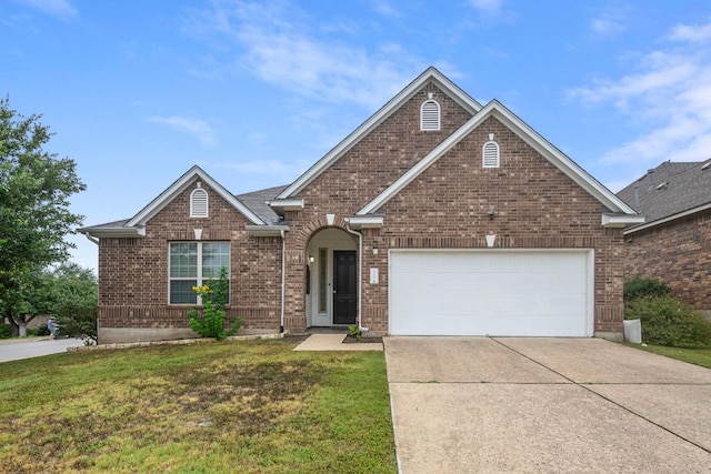 15800 Tetons Ct, Bee Cave, TX 78738 - traditional-style house with driveway, a front yard, brick siding, and a garage