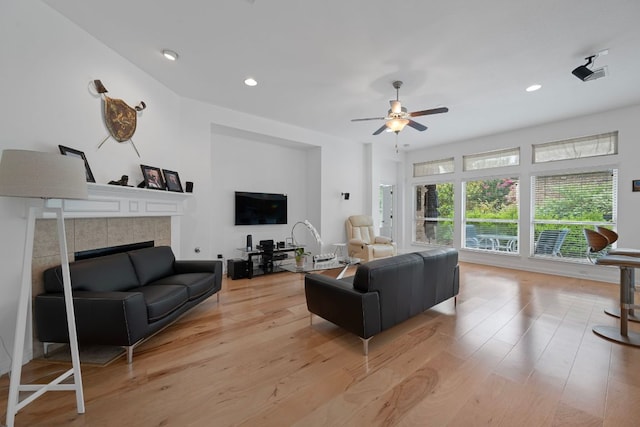 15800 Tetons Ct, Bee Cave, TX 78738 - living room featuring a ceiling fan, a fireplace, light wood finished floors, and recessed lighting