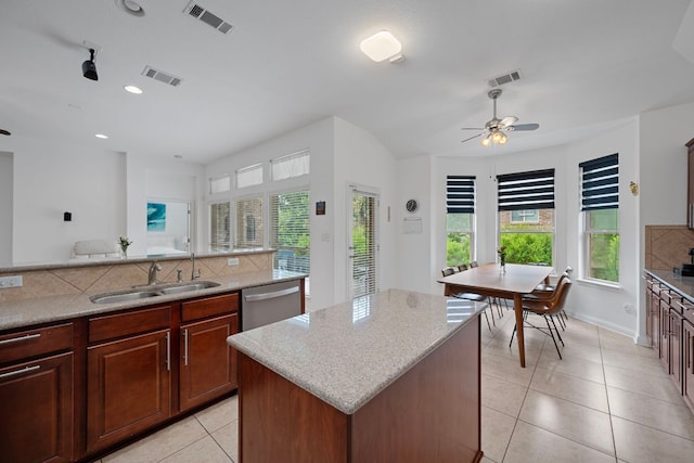 15800 Tetons Ct, Bee Cave, TX 78738 - kitchen featuring dishwasher, plenty of natural light, light tile patterned floors, backsplash, and recessed lighting