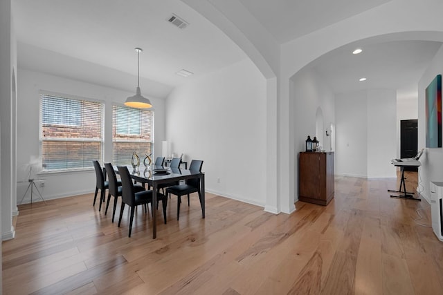 15800 Tetons Ct, Bee Cave, TX 78738 - dining space with arched walkways, light wood-style flooring, and recessed lighting