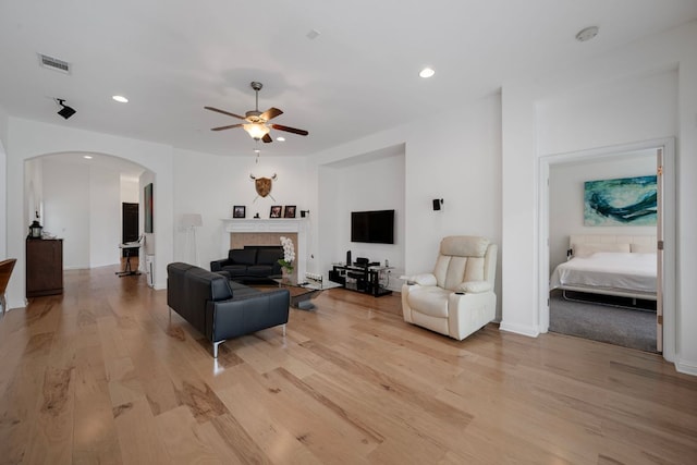 15800 Tetons Ct, Bee Cave, TX 78738 - living room with ceiling fan, arched walkways, light wood-type flooring, recessed lighting, and a fireplace