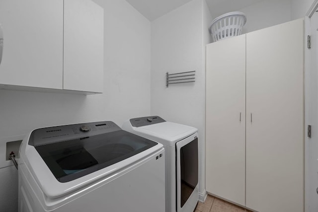 15800 Tetons Ct, Bee Cave, TX 78738 - laundry room with washer and clothes dryer, cabinet space, and light tile patterned flooring