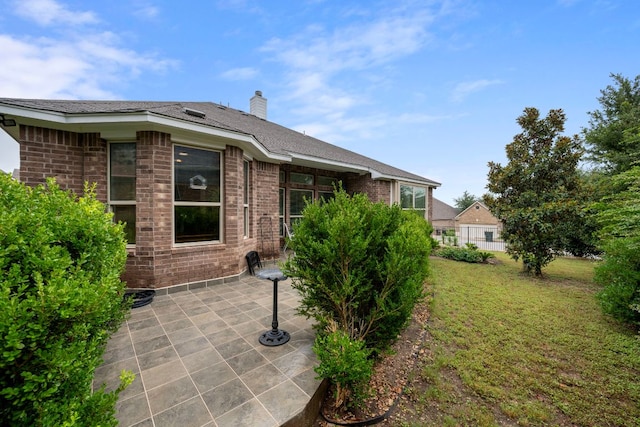 15800 Tetons Ct, Bee Cave, TX 78738 - exterior space with a patio, brick siding, a chimney, and a lawn