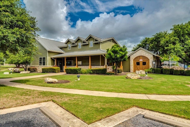 911 Bogart Rd, Cedar Park, TX 78613 - view of front facade featuring stone siding, a front lawn, a metal roof, and a porch