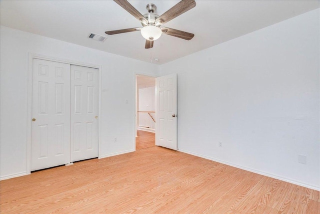 911 Bogart Rd, Cedar Park, TX 78613 - unfurnished bedroom with light wood finished floors, a closet, and ceiling fan