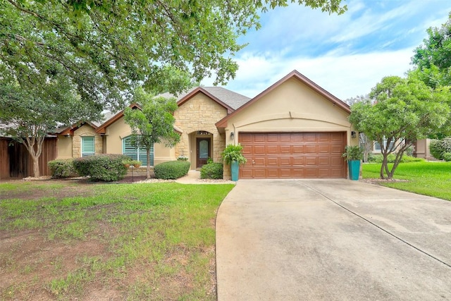 30613 Chi Chi Dr, Georgetown, TX 78628 - ranch-style house featuring stone siding, stucco siding, concrete driveway, a front lawn, and a garage