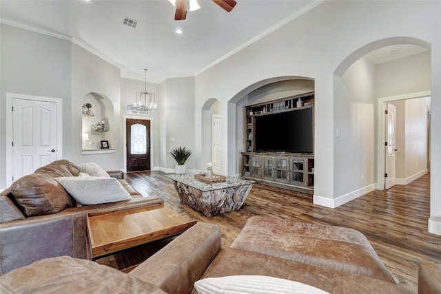 30613 Chi Chi Dr, Georgetown, TX 78628 - living room featuring a ceiling fan, crown molding, wood finished floors, arched walkways, and a towering ceiling
