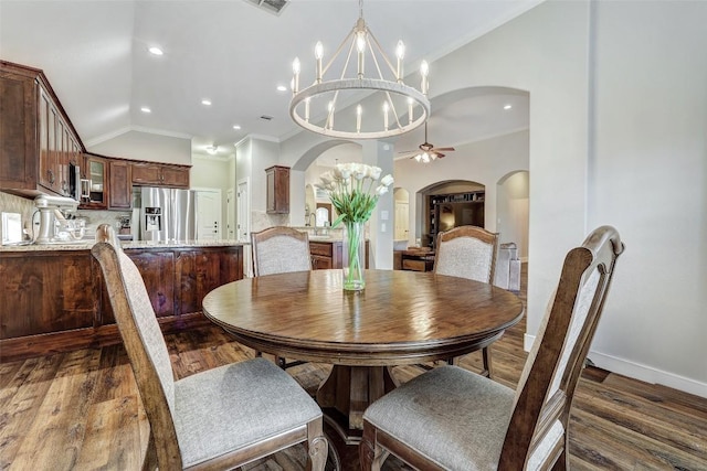 30613 Chi Chi Dr, Georgetown, TX 78628 - dining space with a chandelier, arched walkways, wood finished floors, ornamental molding, and a ceiling fan