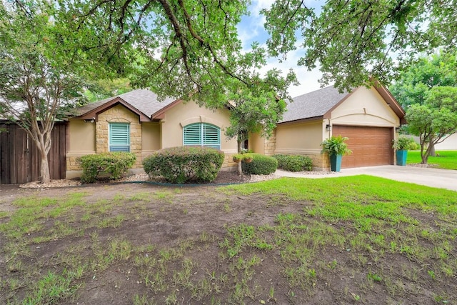 30613 Chi Chi Dr, Georgetown, TX 78628 - ranch-style house featuring stone siding, roof with shingles, a garage, stucco siding, and concrete driveway