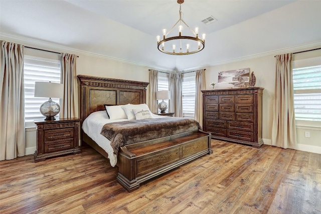 30613 Chi Chi Dr, Georgetown, TX 78628 - bedroom featuring a chandelier, light wood-style flooring, and ornamental molding