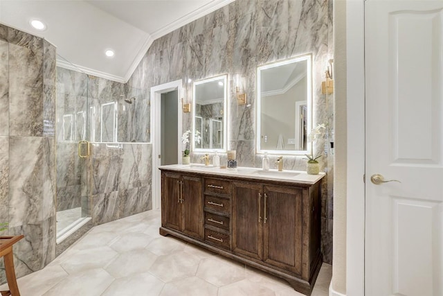 30613 Chi Chi Dr, Georgetown, TX 78628 - full bathroom featuring crown molding, a marble finish shower, double vanity, vaulted ceiling, and tile walls