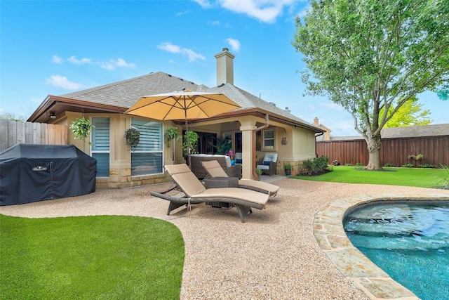 30613 Chi Chi Dr, Georgetown, TX 78628 - back of property with stone siding, a patio area, a fenced backyard, roof with shingles, and a chimney