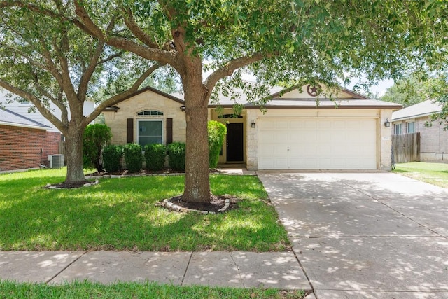 3710 Castle Rock Dr, Round Rock, TX 78681 - ranch-style home featuring a front yard, driveway, a garage, and stone siding