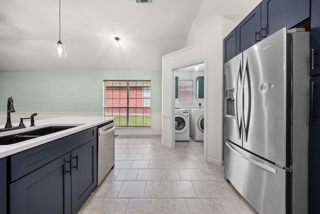 1409 Castle Ridge Dr, Harker Heights, TX 76548 - kitchen featuring appliances with stainless steel finishes, washer and clothes dryer, lofted ceiling, light countertops, and hanging light fixtures