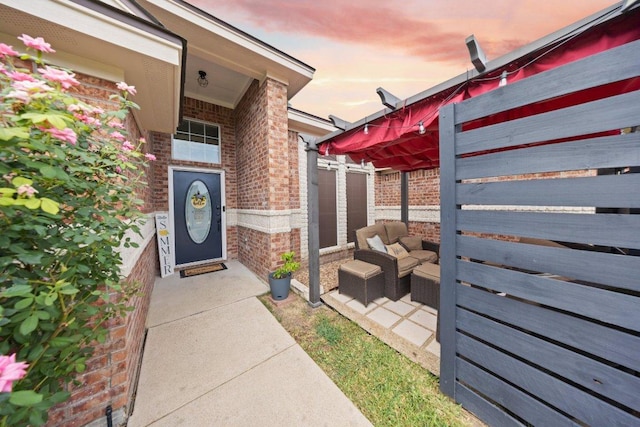 1409 Castle Ridge Dr, Harker Heights, TX 76548 - exterior entry at dusk with brick siding and outdoor lounge area