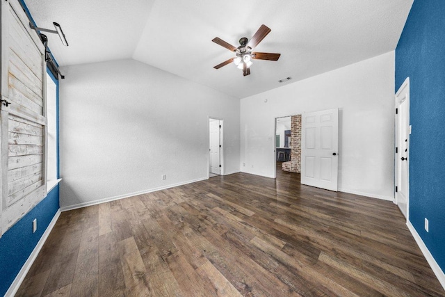1409 Castle Ridge Dr, Harker Heights, TX 76548 - unfurnished bedroom with a barn door, vaulted ceiling, wood finished floors, and a ceiling fan