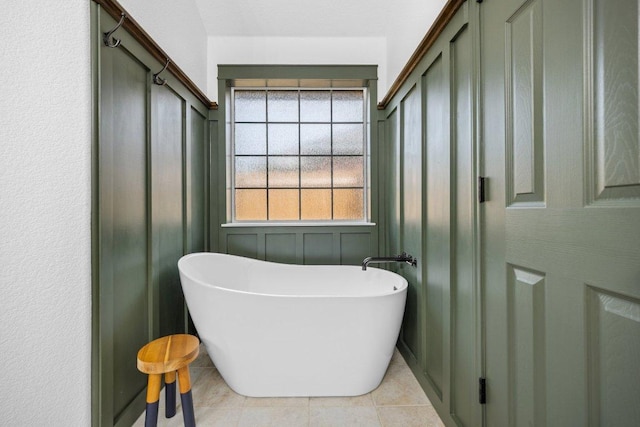 1409 Castle Ridge Dr, Harker Heights, TX 76548 - bathroom with a freestanding bath, tile patterned floors, a decorative wall, and a closet