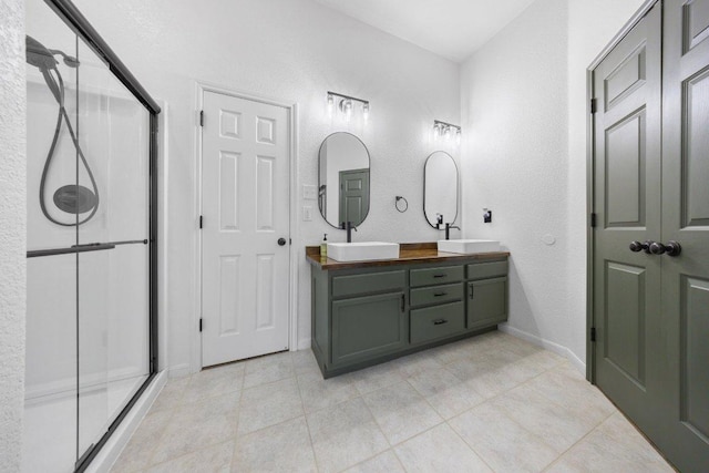 1409 Castle Ridge Dr, Harker Heights, TX 76548 - full bathroom featuring double vanity, a shower stall, tile patterned flooring, and a textured wall