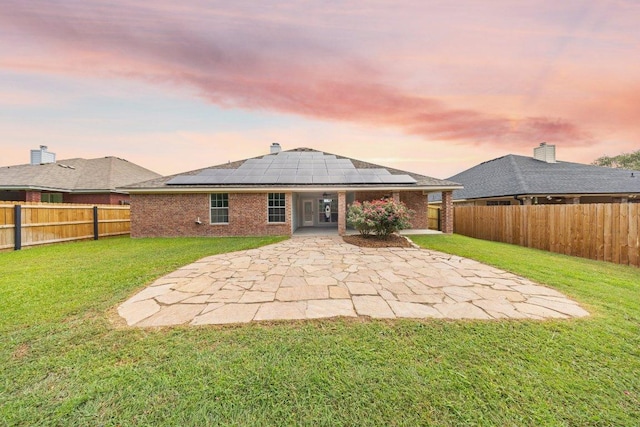 1409 Castle Ridge Dr, Harker Heights, TX 76548 - rear view of house featuring a patio, solar panels, a fenced backyard, and french doors