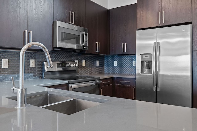 3600 S Lamar Blvd Unit 501, Austin, TX 78704 - kitchen with stainless steel appliances, decorative backsplash, dark brown cabinetry, and light countertops