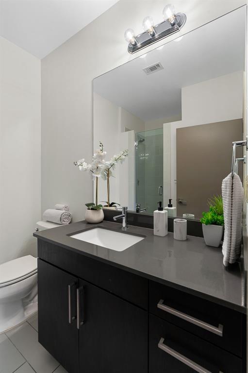 3600 S Lamar Blvd Unit 501, Austin, TX 78704 - bathroom with vanity, a stall shower, and tile patterned flooring