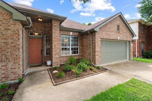 16907 Cranston Dr, Round Rock, TX 78664 - doorway to property with driveway, an attached garage, and brick siding