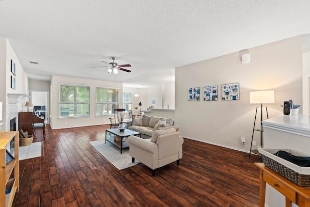 16907 Cranston Dr, Round Rock, TX 78664 - living area featuring hardwood / wood-style floors, ceiling fan, a textured ceiling, and a fireplace