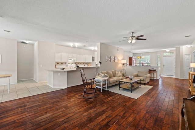 16907 Cranston Dr, Round Rock, TX 78664 - living area featuring light wood finished floors, a ceiling fan, and a textured ceiling
