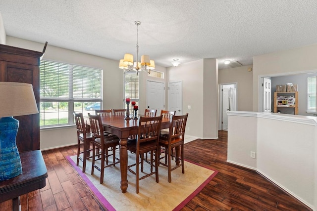 16907 Cranston Dr, Round Rock, TX 78664 - dining room featuring a chandelier, a textured ceiling, and dark wood-type flooring