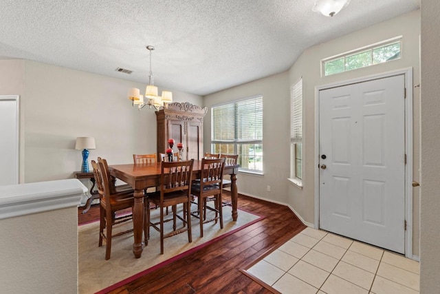 16907 Cranston Dr, Round Rock, TX 78664 - dining room featuring a chandelier, healthy amount of natural light, light wood finished floors, and a textured ceiling