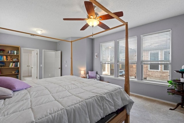 16907 Cranston Dr, Round Rock, TX 78664 - bedroom with carpet flooring, a textured ceiling, and a ceiling fan