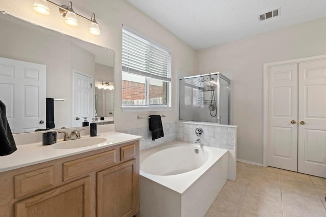 16907 Cranston Dr, Round Rock, TX 78664 - bathroom featuring a garden tub, a stall shower, vanity, and tile patterned floors
