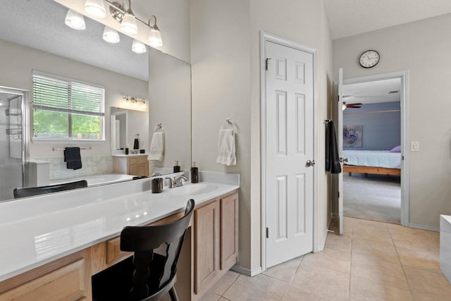 16907 Cranston Dr, Round Rock, TX 78664 - bathroom with vanity, ensuite bath, tile patterned floors, a shower stall, and a bathtub