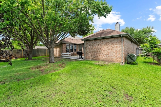 16907 Cranston Dr, Round Rock, TX 78664 - rear view of house featuring a chimney, brick siding, a fenced backyard, and a patio area