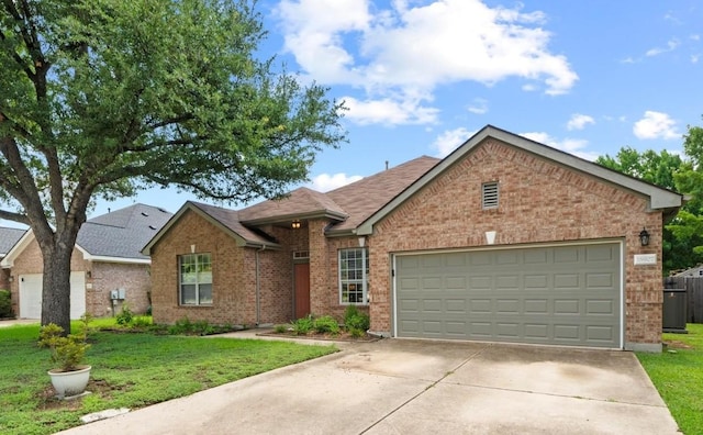 16907 Cranston Dr, Round Rock, TX 78664 - ranch-style house with brick siding, concrete driveway, a front yard, an attached garage, and roof with shingles