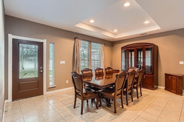 195 Heritage Oaks Dr, Cedar Creek, TX 78612 - dining area featuring light tile patterned floors, recessed lighting, a tray ceiling, and arched walkways