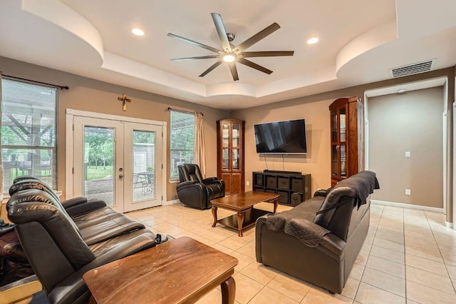 195 Heritage Oaks Dr, Cedar Creek, TX 78612 - living area with french doors, a raised ceiling, a ceiling fan, light tile patterned floors, and recessed lighting