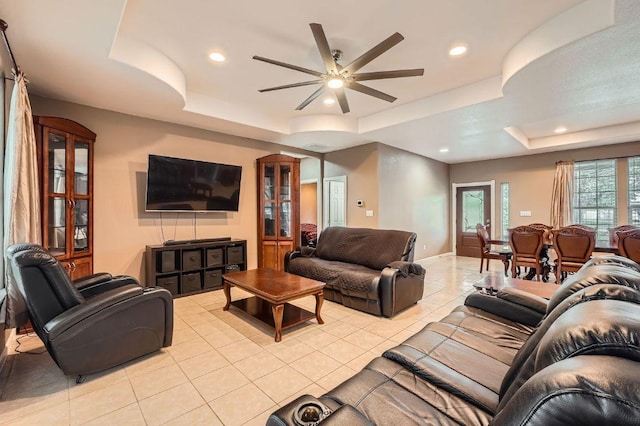 195 Heritage Oaks Dr, Cedar Creek, TX 78612 - living room featuring a tray ceiling, light tile patterned floors, recessed lighting, and a ceiling fan
