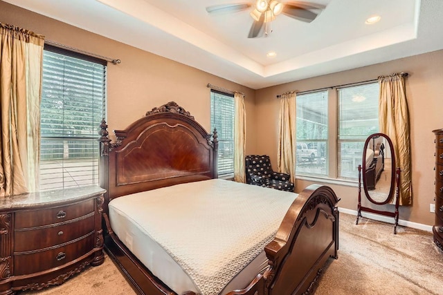 195 Heritage Oaks Dr, Cedar Creek, TX 78612 - bedroom with a tray ceiling, light colored carpet, recessed lighting, and a ceiling fan
